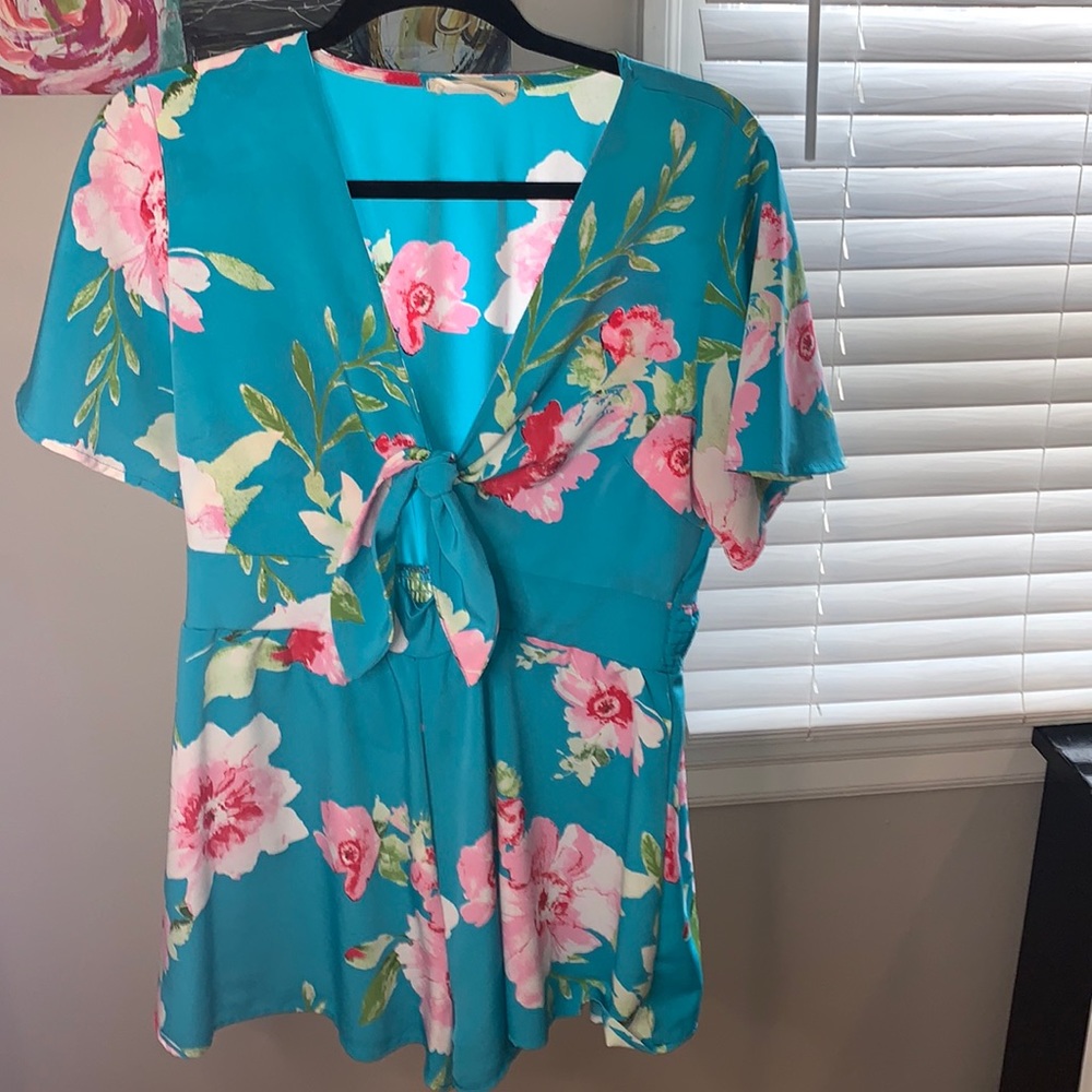 Adorable front tie cut out romper from Pink Lilly